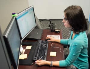 lady at her desk using a computer