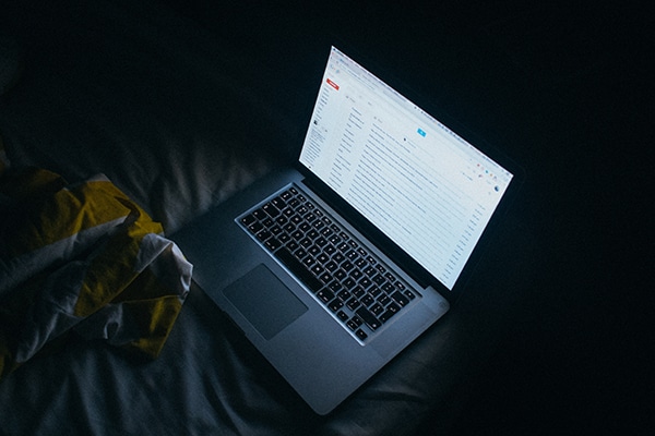 laptop computer glowing in the dark