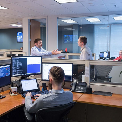 team of people spread out over the office using computers